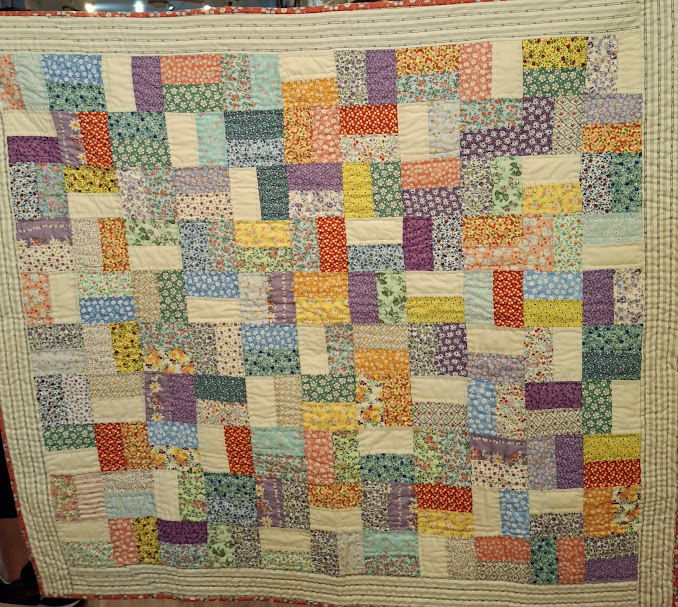 This lap quilt was made entirely by hand by one of the newer Cotton Quilters members as a challenge from some of the older members.