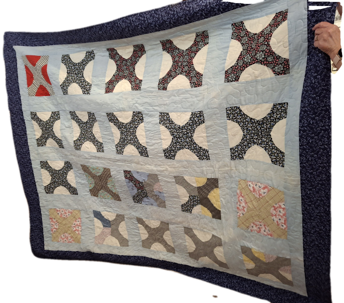 A vintage, hand-sewn quilt top made  by Beth's grandmother. She finished it to make a lap-size quilt.