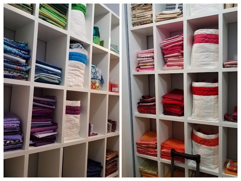 Cubbies with cloth bins organize scraps, fat quarters, and precuts