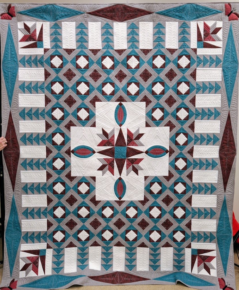 GSQA quilt in teal, beige, and browns. 