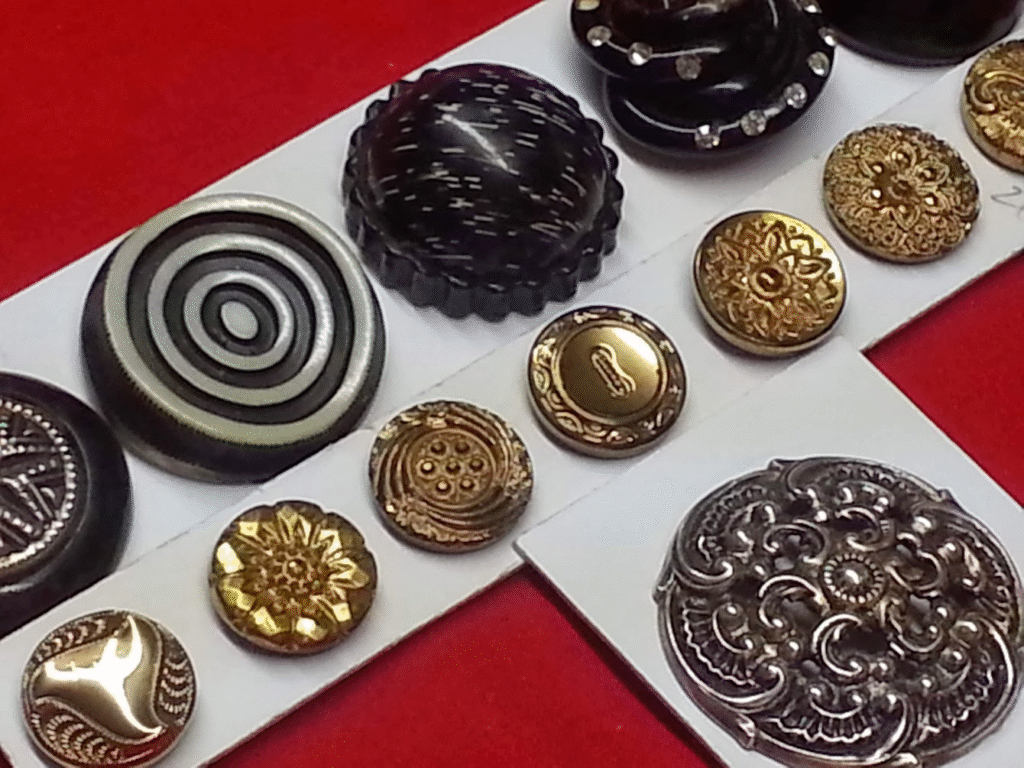 Sets of antique buttons, one black, one set gold, and a single large 1.5" silver.