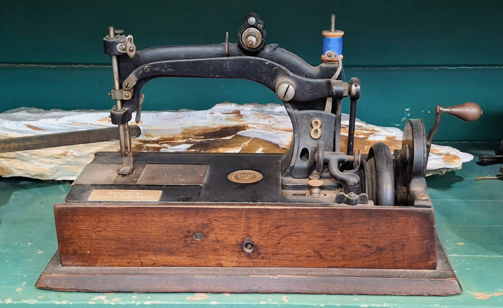 An old hand-crank sewing machine that looks like it's still in working order.
