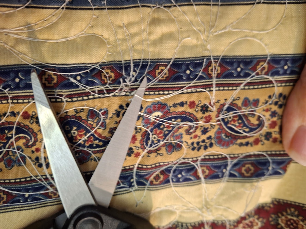 All blocks on this post show how Mary removed loose stitches from the back of a quilt.